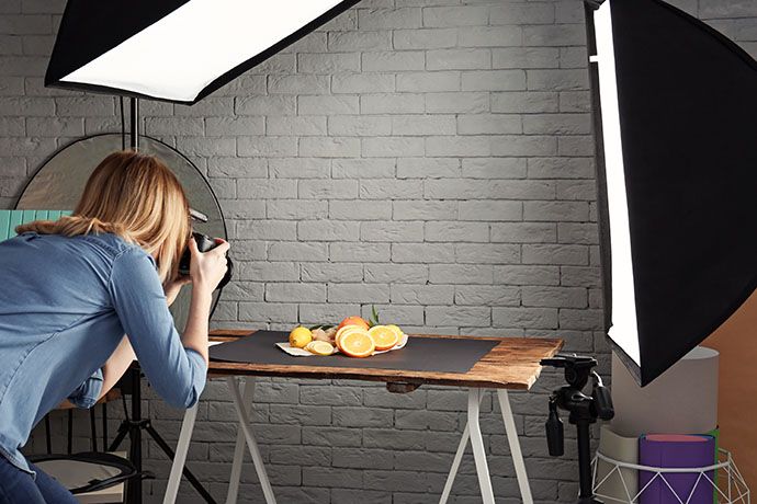 woman-taking-photo-of-food-with-professional-camera-in-studio