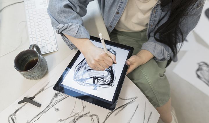 A person drawing in Adobe Fresco