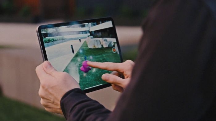  Person playing a mobile AR game with a tablet