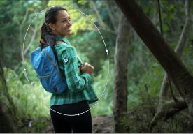 A hiker looks back at the camera during a hike with the Adobe Photoshop radial filter being applied