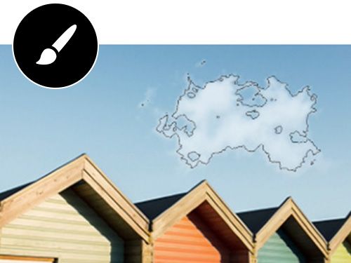 Clouds are outlined over a row of tiny homes before modifying them with the brush symbol overlaid