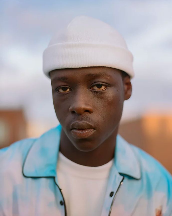 Man in white beanie hat captured in portrait photograph