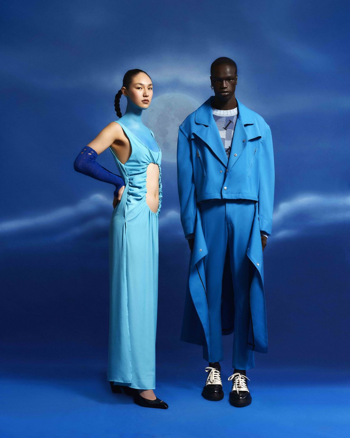 Two fashion models in all-blue setting.