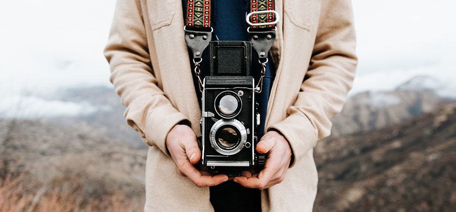 A person holding a film camera