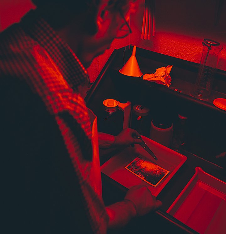 A person developing film in a darkroom