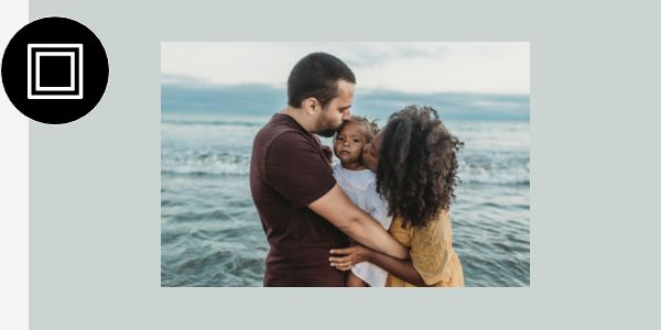 A photo of a family with a white frame added around it.