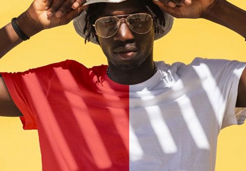 A photo of a person wearing a shirt that is red on the left half and white on the right half.