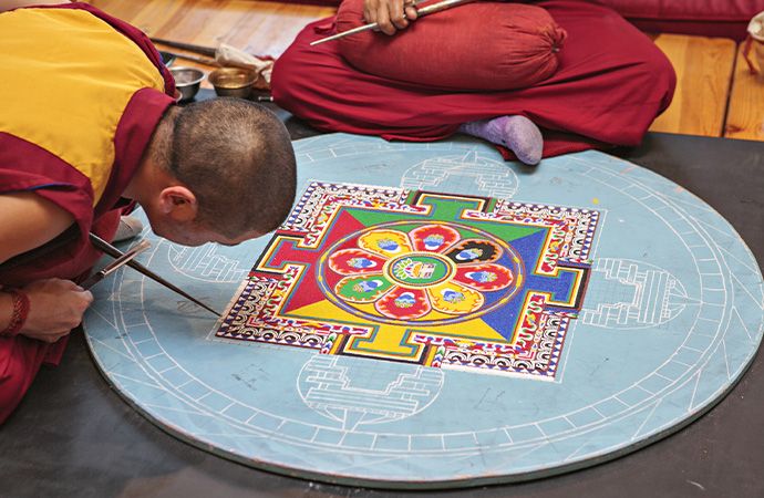 Buddhist monks making a sand mandala