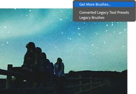 Star gazers on a fence are overwhelmed by a bright teal night sky with Get More Brushes dialog box overlaid