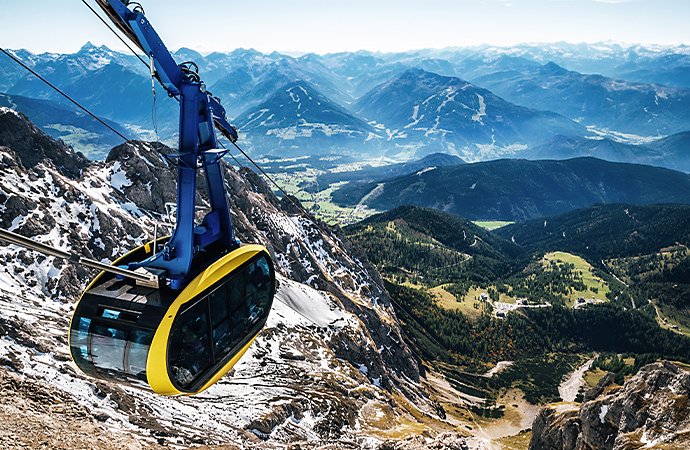 A travel photo of a gondola to the mountain peak of Dachstein glacier in Austrian Alps