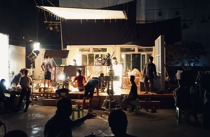 A video production set filled with people working on the set